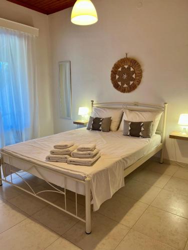 a bedroom with a large bed with towels on it at Gaia Limnos Apartments 1 & 2 in Kornós
