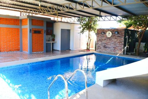 a large swimming pool in a house with a building at Casa Completa in Rancho San Pedro