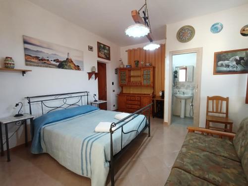 a bedroom with a bed and a living room at Villa Panorama in Lipari