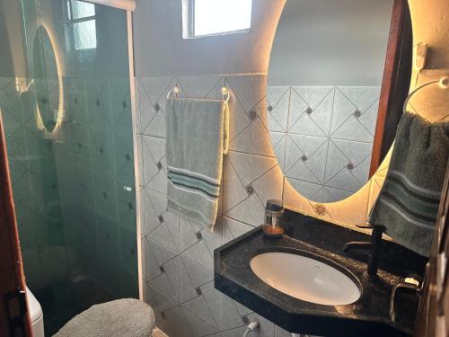 a bathroom with a sink and a mirror at Villa Serena in Castanhal