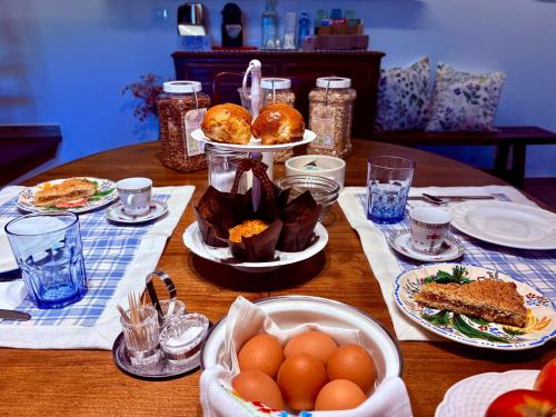 a table with plates of food and eggs on it at RoncoBèrtolo R&B in Loiano