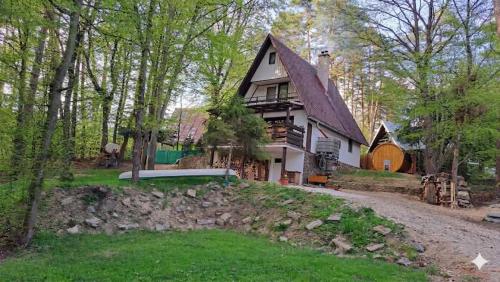 a large white house with a gambrel roof at Chata Ružín nad Vodou in Margecany