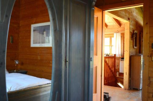 a bedroom with a bed in a wooden cabin at Blockhaus Rosa Reischl in Neubeuern