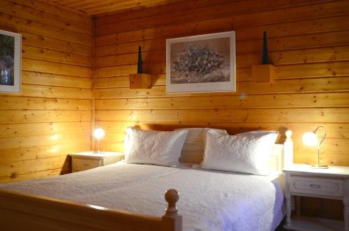a bedroom with a bed in a wooden room at Blockhaus Rosa Reischl in Neubeuern