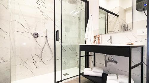 a bathroom with a shower and a sink at Suiteincenter Rooms in Palermo