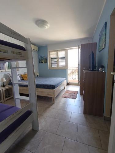 a bedroom with a bed and a bunk bed at Villa Olma in Okrug Gornji
