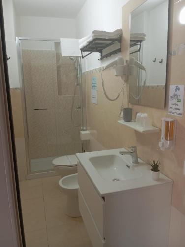 a bathroom with a sink and a toilet and a mirror at B&B La Casa Du Barone in Falcone