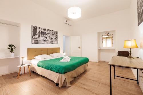 a bedroom with a large green bed in a room at Ottaviano Lodge in Rome
