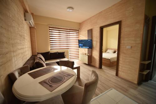 a living room with a table and a couch at Apartman Valentina Aqua Park in Jagodina