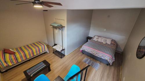a small room with a bed and a table and chairs at La Valentina in Purmamarca