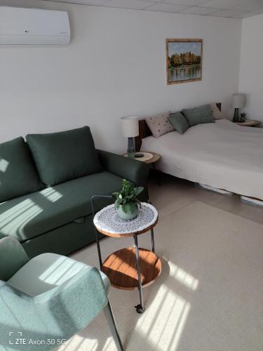 a living room with a couch and a table at Gólya Vendégház in Tiszaug