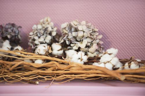 a pile of white flowers in a wicker basket at Cristal Hôtel Restaurant - Logis Hotels in Saumur