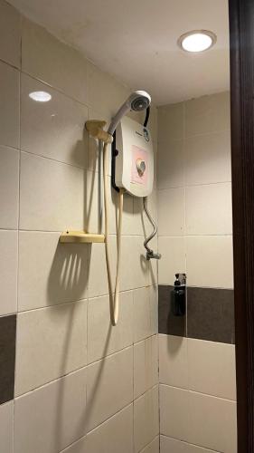 a bathroom with a blow dryer on a wall at Perdana Hotel Labuan in Labuan