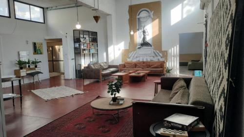 a living room with a couch and a table at Rooms next to Florentine with bomb shelter inside the building in Tel Aviv