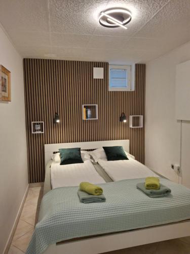 a bedroom with a bed with two towels on it at Apartments Villa Bazilika in Sečovlje