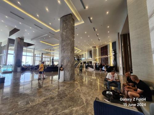 a lobby with people sitting in chairs in a building at Cosy Romantic Sea View Villa at a 5 Hotel in Sharm El Sheikh
