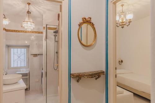 a bathroom with a shower and a sink and a mirror at Appartamento Splendore in Bellagio