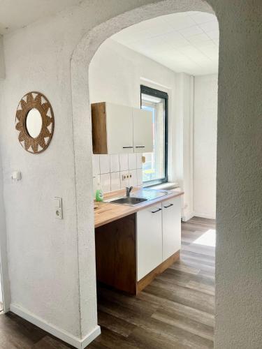 a kitchen with a sink and a counter top at Green Loft - Haus der Natur in Spiesen-Elversberg