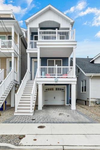a large white house with a large garage at Cozy Shoregri La! - Beach block! in Seaside Heights