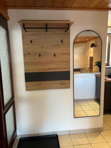 a mirror on a wall in a room with a counter at Staufen Stern in Oberstaufen