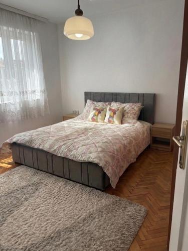 a bedroom with a large bed with two pillows at Al Centro in Peje