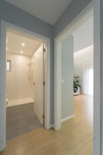 an empty living room with a door leading to a hallway at Nascer Do Sol Retreat Villa in Conceição