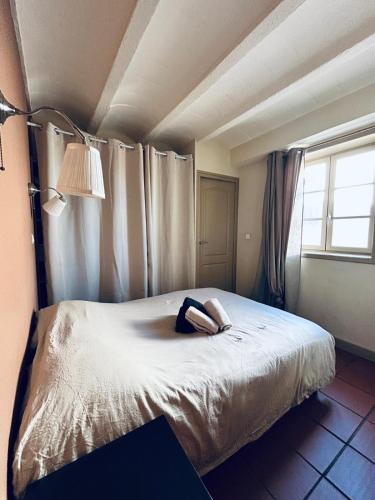 a bedroom with a bed with a robe on it at I Love Perpignan Duplex Terrasse in Perpignan