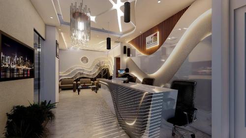 a lobby with a bar with chairs and a chandelier at Hotel Adi International in Rājshāhi