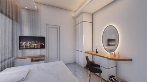 a bedroom with a bed and a mirror at Hotel Adi International in Rājshāhi