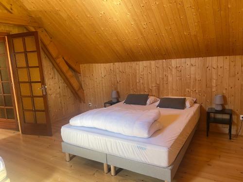 a bedroom with a large bed in a attic at Le chalet de Pierrot in La Malène