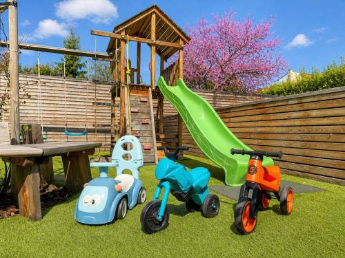 three toys sitting on the grass next to a playground at Čajkovskij Apartments in Brno