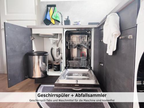 a kitchen with a dishwasher with a sink in it at GlanzExperts Auszeit bei Berlin Balkon Kicker & DisneyPlus in Zossen