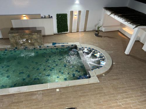 a large pool of water in a room with a piano at Grande Villa Familiale Route Du Phare in Djerba