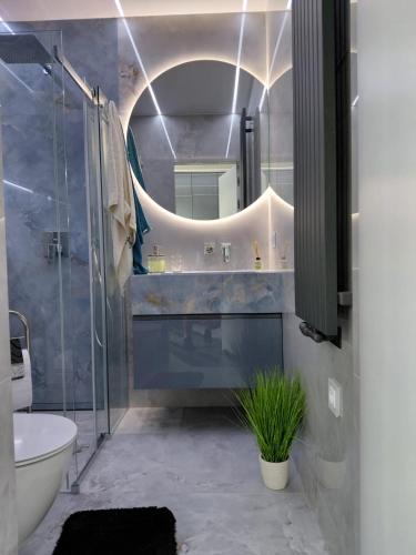 a bathroom with a sink and a mirror and a tub at KLIMKOWSKA osada in Klimkówka