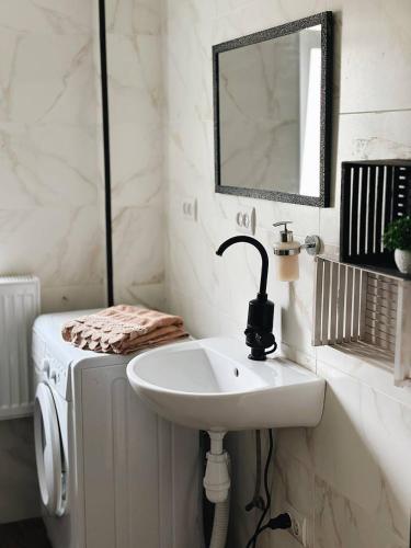 a bathroom with a sink and a mirror at Зелена долина in Solgutovo