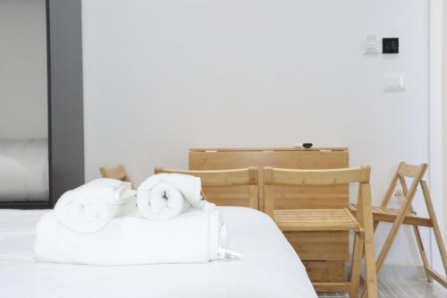 two towels sitting on top of a bed at Aura boutique hotel in Vlorë