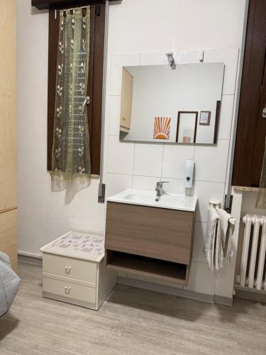 a bathroom with a sink and a mirror at Alloggi Al Giardino & La Suite in Occhiobello