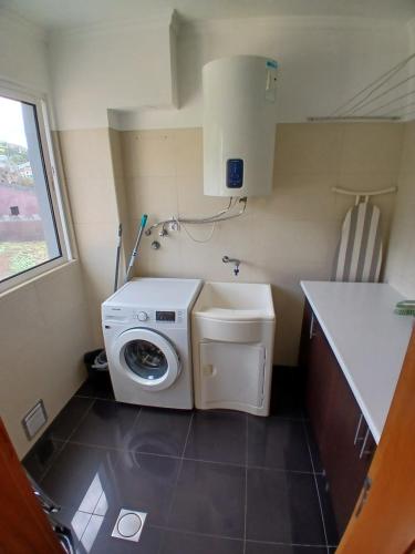 a washer and dryer in a small bathroom at Al-Solares in Santa Cruz