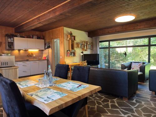 a dining room with a wooden table and chairs at Großes Ferienhaus fuer 8 Personen, Manderscheid in Manderscheid