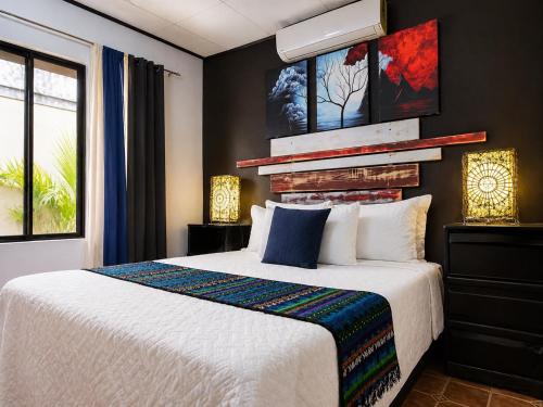 a bedroom with a large white bed in a room at Casa Olas in Quepos