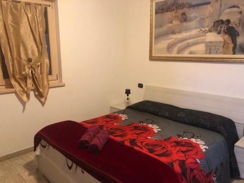 a bedroom with a bed with red roses on it at Vita sul Garda in Bardolino