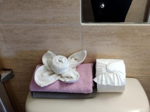 a pile of towels sitting on top of a toilet at Beach-side condos at Turtle Beach Towers in Ocho Rios
