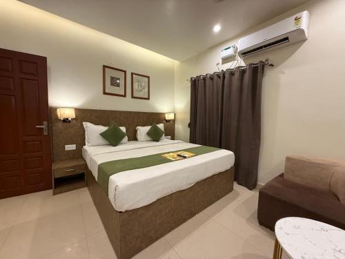 a hotel room with a bed and a chair at RJ14 Accommodations at Baga Beach in Baga