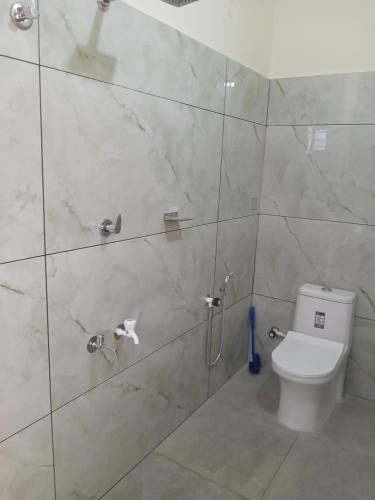 a bathroom with a toilet and a shower at Dolphin beach in Varkala