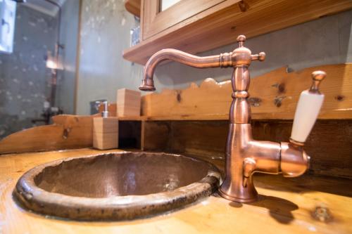 a copper sink with a candle on a wooden counter at Almond Suite in Hydra