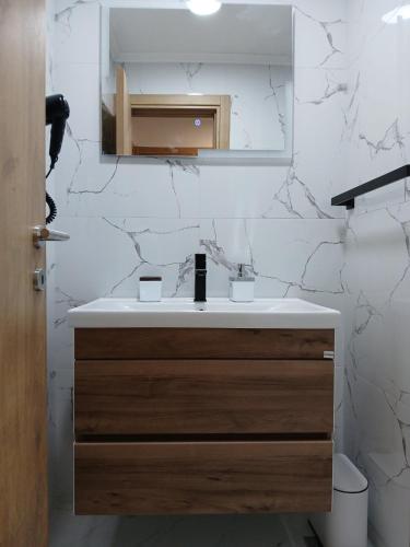 a bathroom with a sink and a mirror at CasaBlanca in Trebinje
