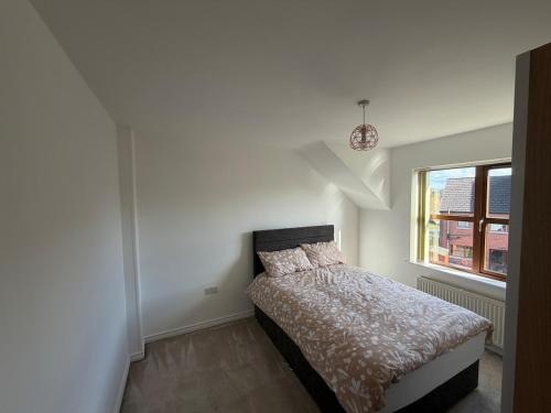 a bedroom with a bed in a white room at Relax In Belfast in Belfast