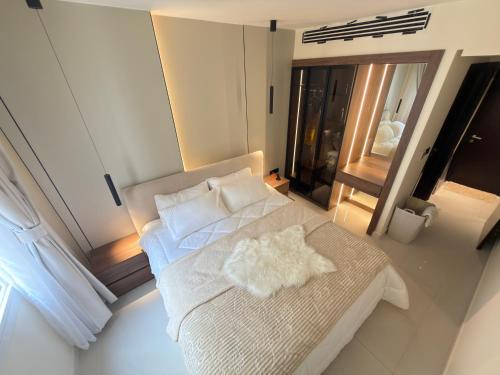 a bedroom with a white bed and a window at Copper Living in Muscat