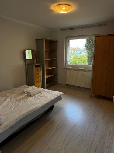 a bedroom with a bed and a window at Mała Tyczkówka in Stężyca