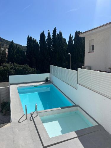 a swimming pool on the side of a house at Casa Roca Maura in L'Estartit